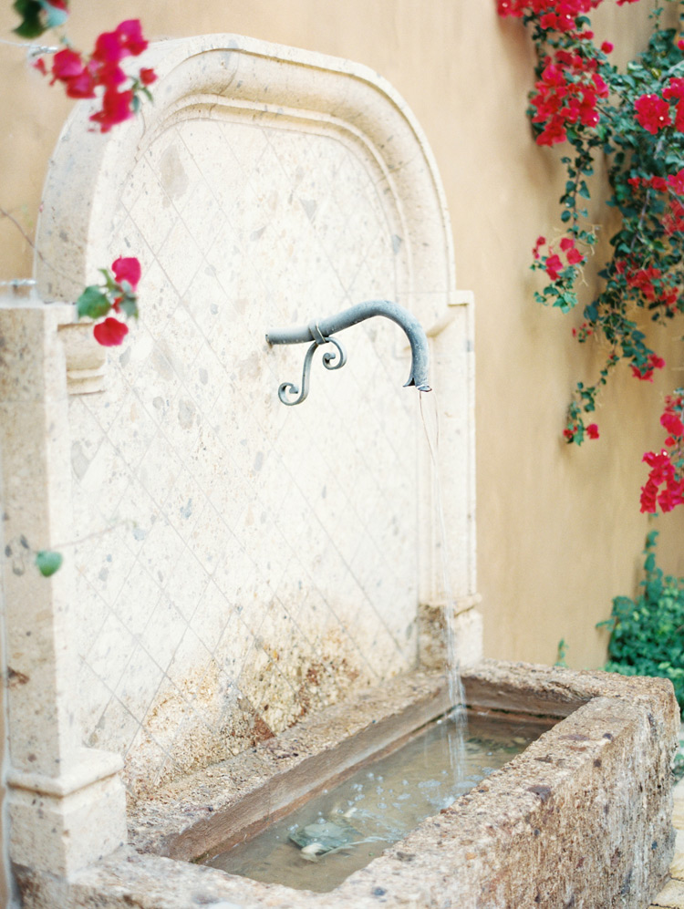Outdoor water feature in warm tile. Old world style in outdoor decorating. 
