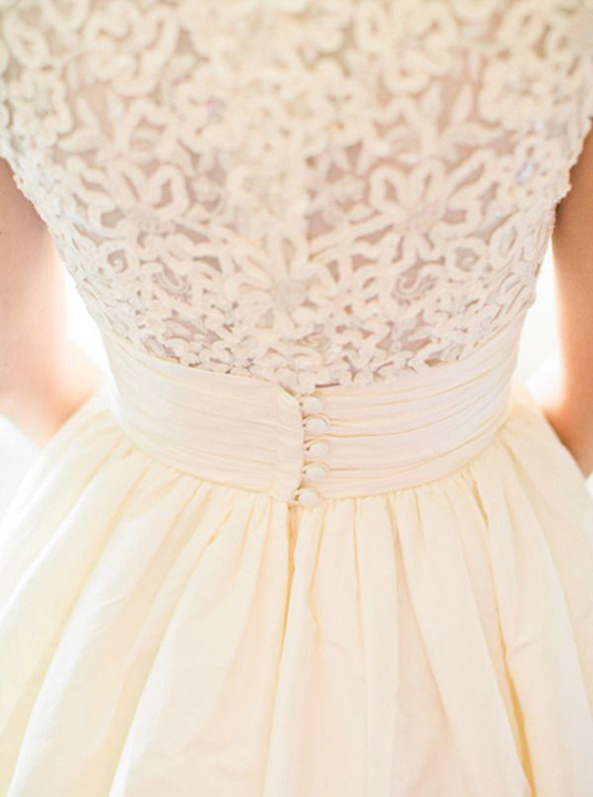 Simple and elegant ivory wedding dress with lace back detail and buttons. 