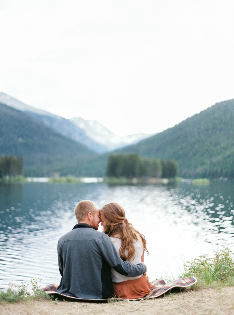 Cuddles and view front for engaged couple in Colorado session