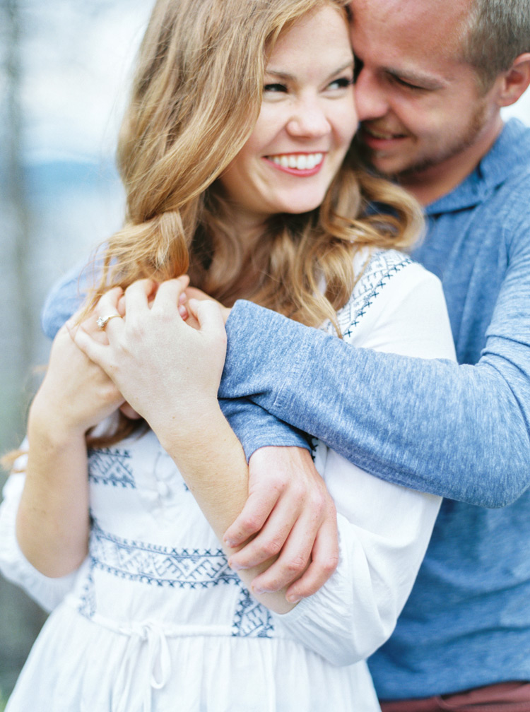 Special up close moment of groom holding his fiancé outdoor photo shoot