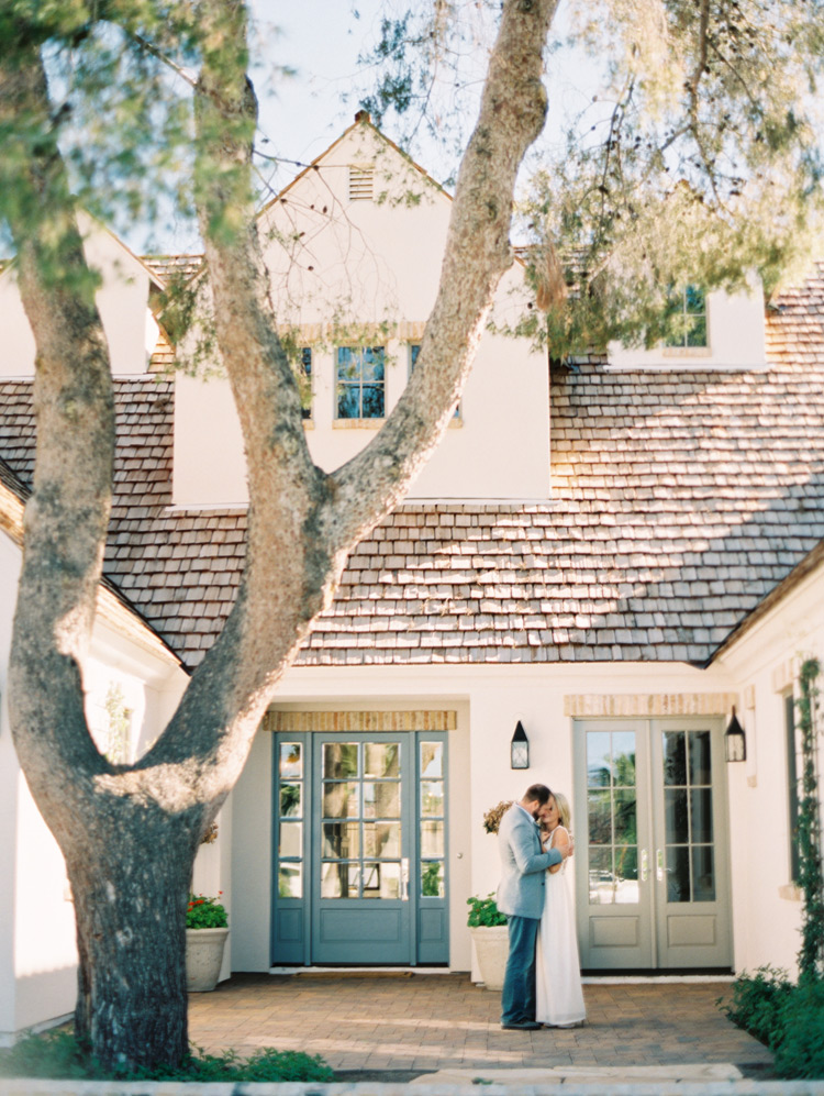 Engagement shoot at home. Domestic romance as a couple embraces in front of  their Arizona home. 