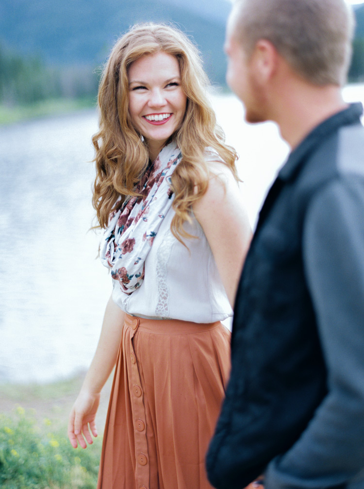 Joyful bride looking at her groom in outdoors session