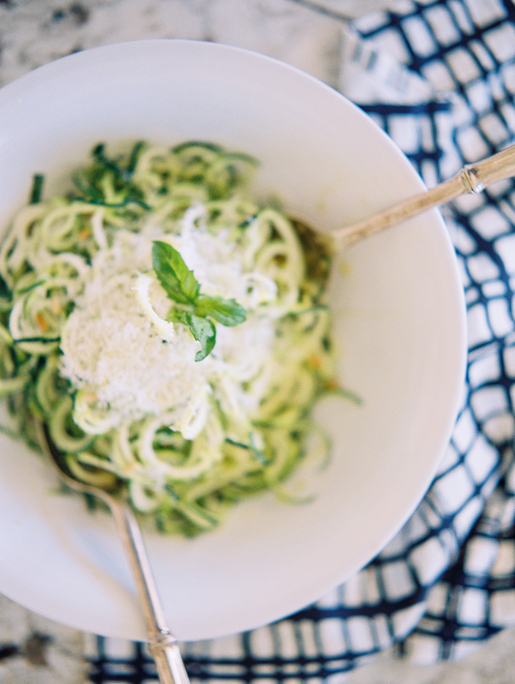 Cooking together in their home kitchen. Zucchini pasta. Engagement shoot ideas.