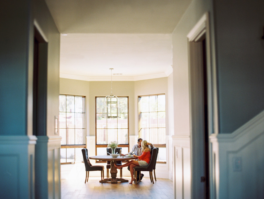 Eating together in their sunlight breakfast nook. Engagement shoot at home. Food and love.