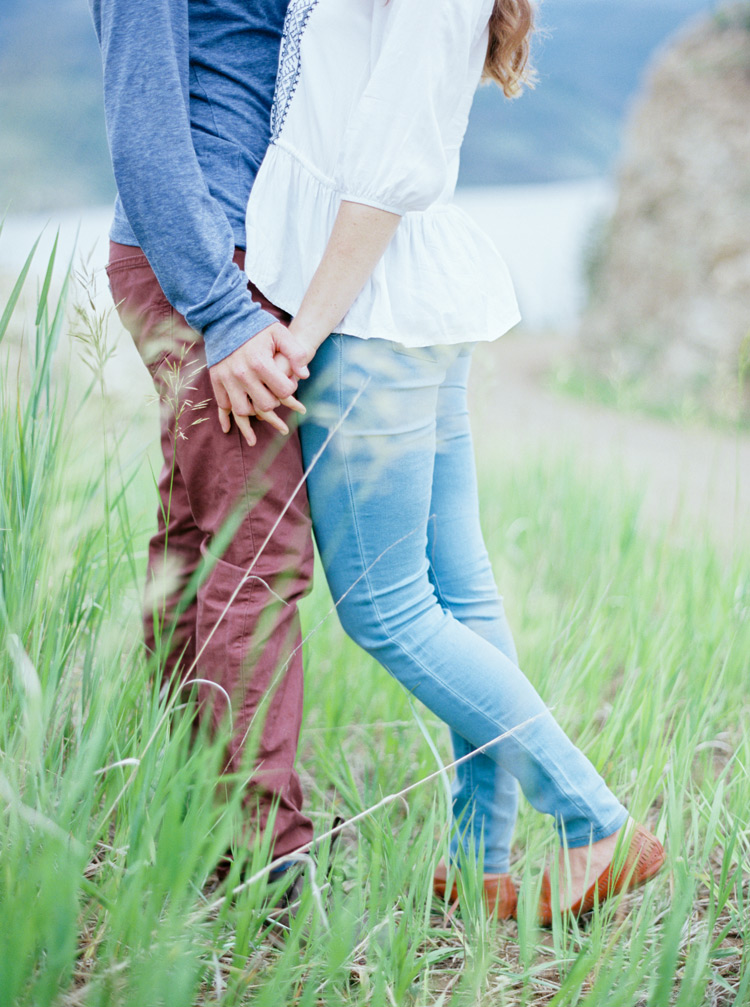 Holding hands in the green fields of Colorado Rockies