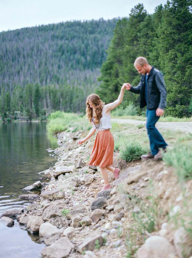 A helping hand to keep his lady safe! Lakeside Colorado engagement photos full of love and joy!