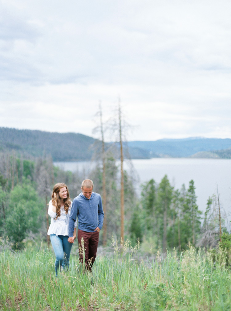 Holding hands and enjoying the outdoors. Colorado lakeside engagement photos. 