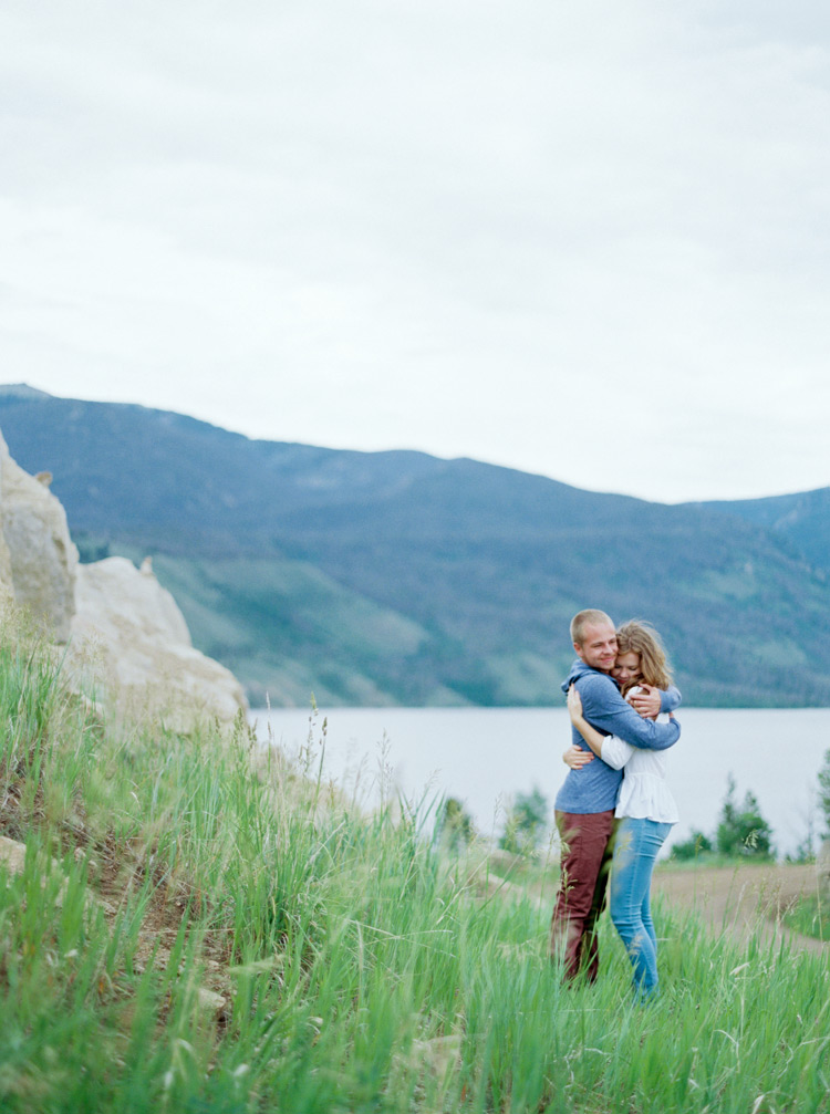 In love engaged couple hugging in open fields Rocky, Colorado