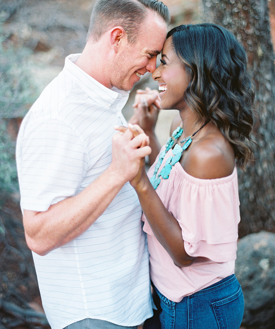 Laughter and love during a Sedona engagement shoot. Natural photo posing. 