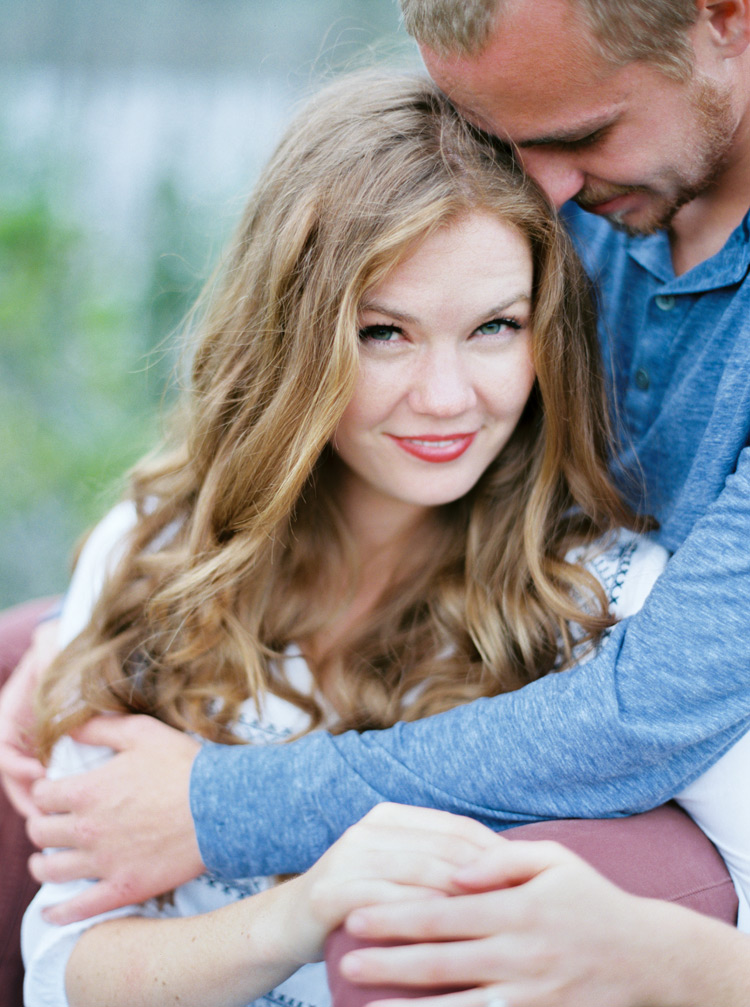 Bride focus as groom holds her close engagement shoot in Colorado