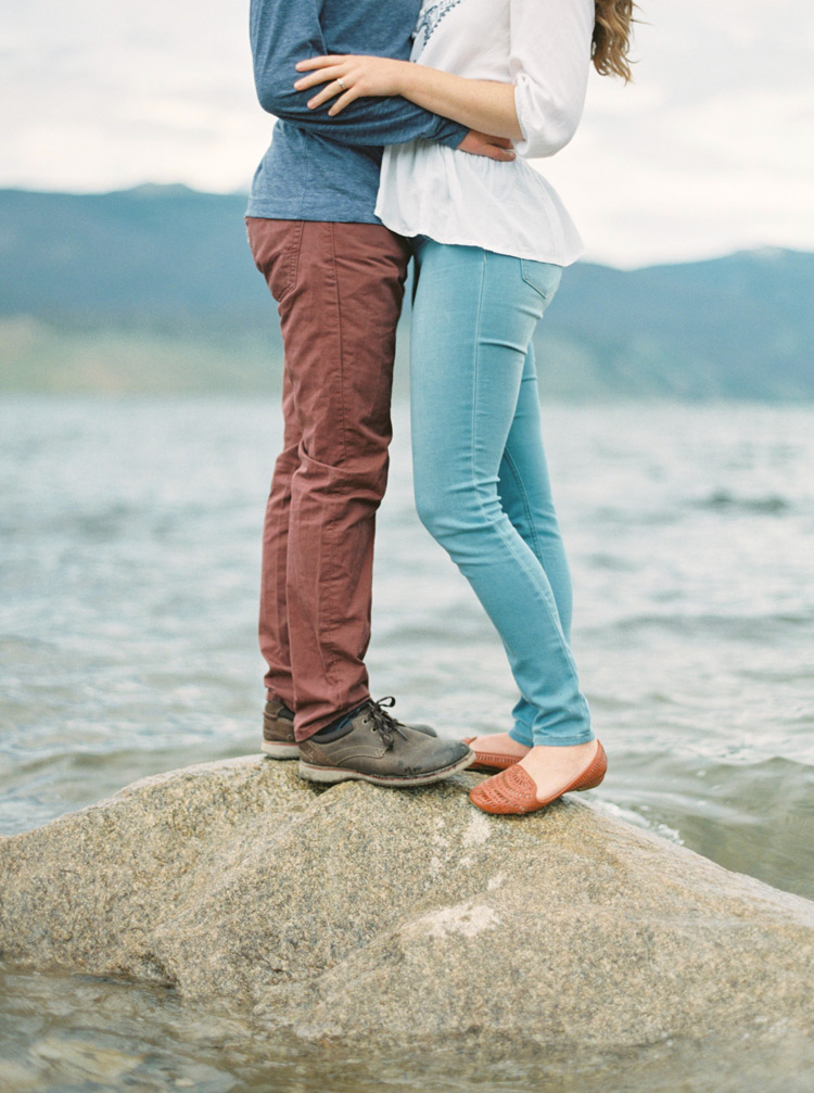 Couple held closely on rock in Colorado lake