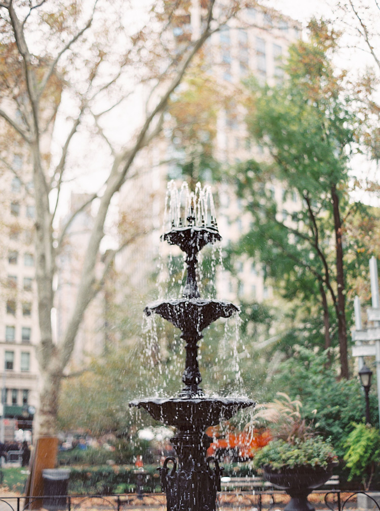 Water flows down a decorative fountain in New York City. Autumn in Central Park, NYC