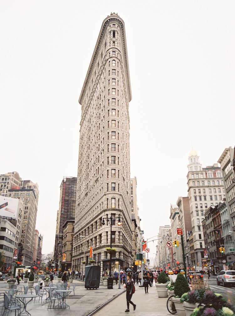 Street view of the Flatiron Building in New York City. Candid city life in the Fall.