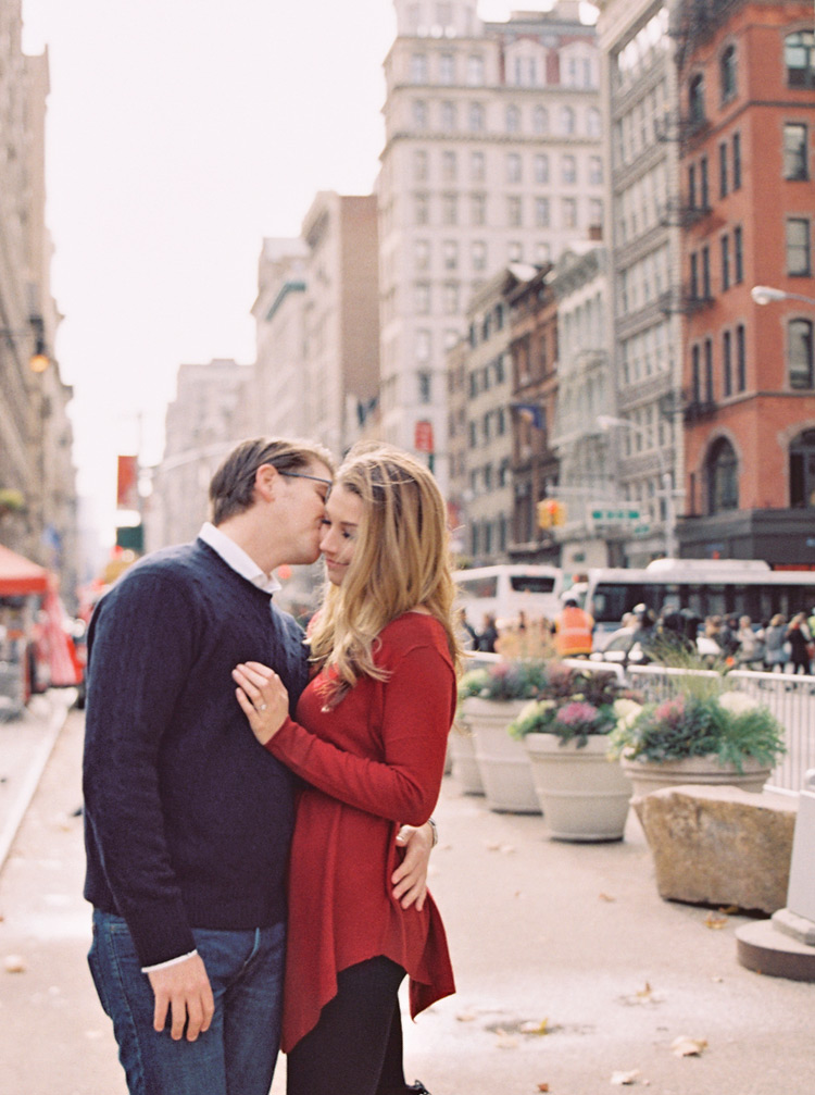 Affectionate couple cuddles on the streets of New York in autumn. Romantic portrait in NYC.