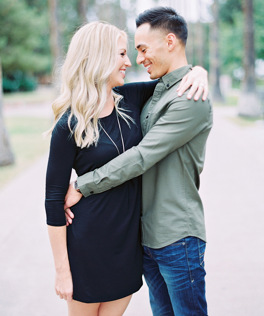 simple black dress on her; olive green on him