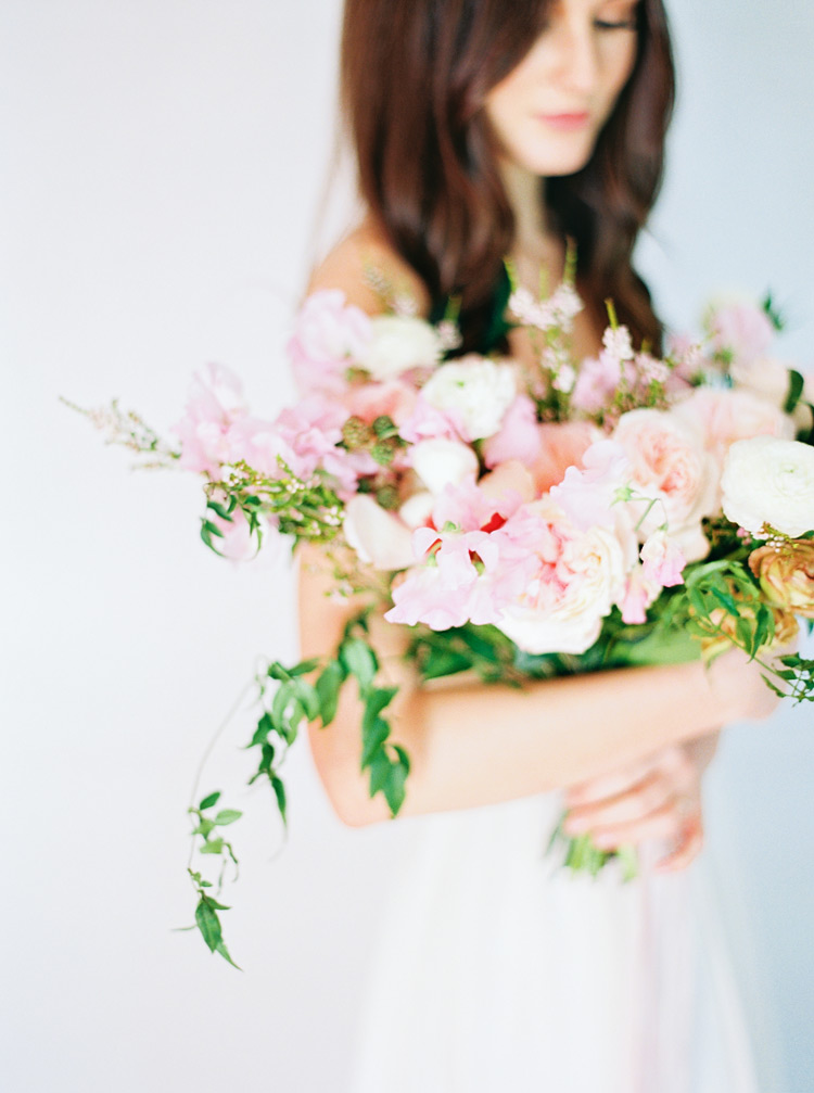 Armful of soft pink flowers in a natural, organic design. 
