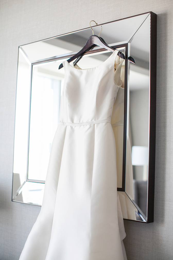 The wedding gown hangs ready for the bride.