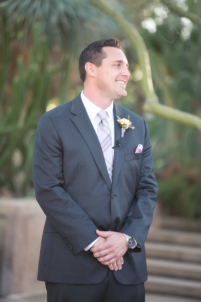 The groom happily awaits his bride. Outdoor wedding ceremony.