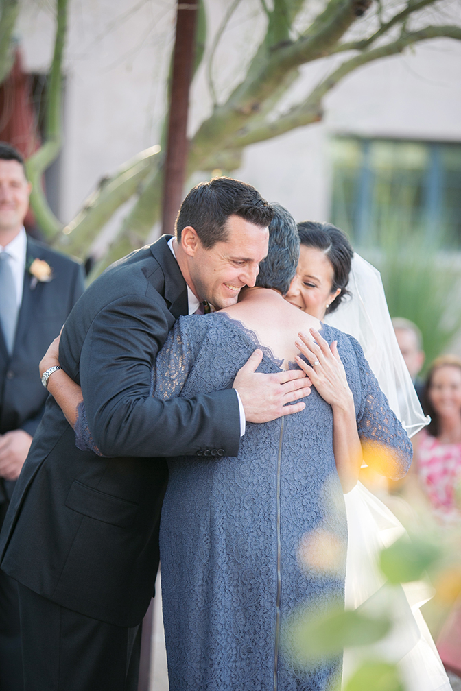 Mother of the bride welcomes the groom at the ceremony. Outdoor wedding.