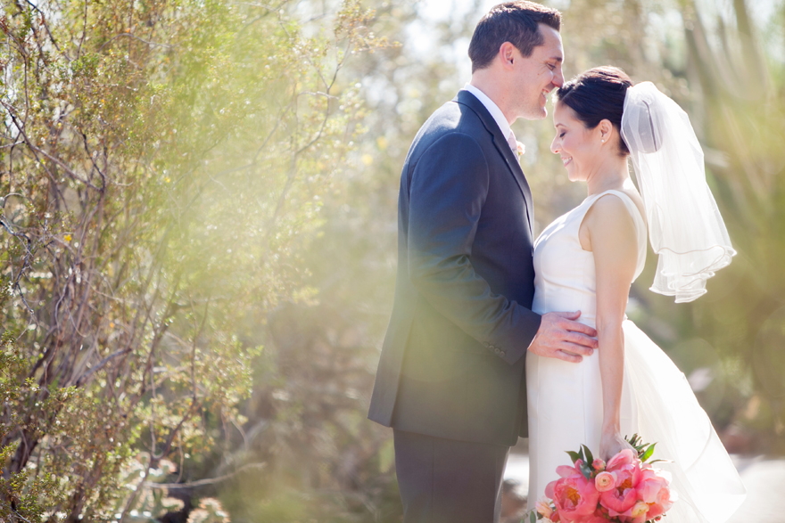 Joyful bride & groom share a moment on their wedding day.