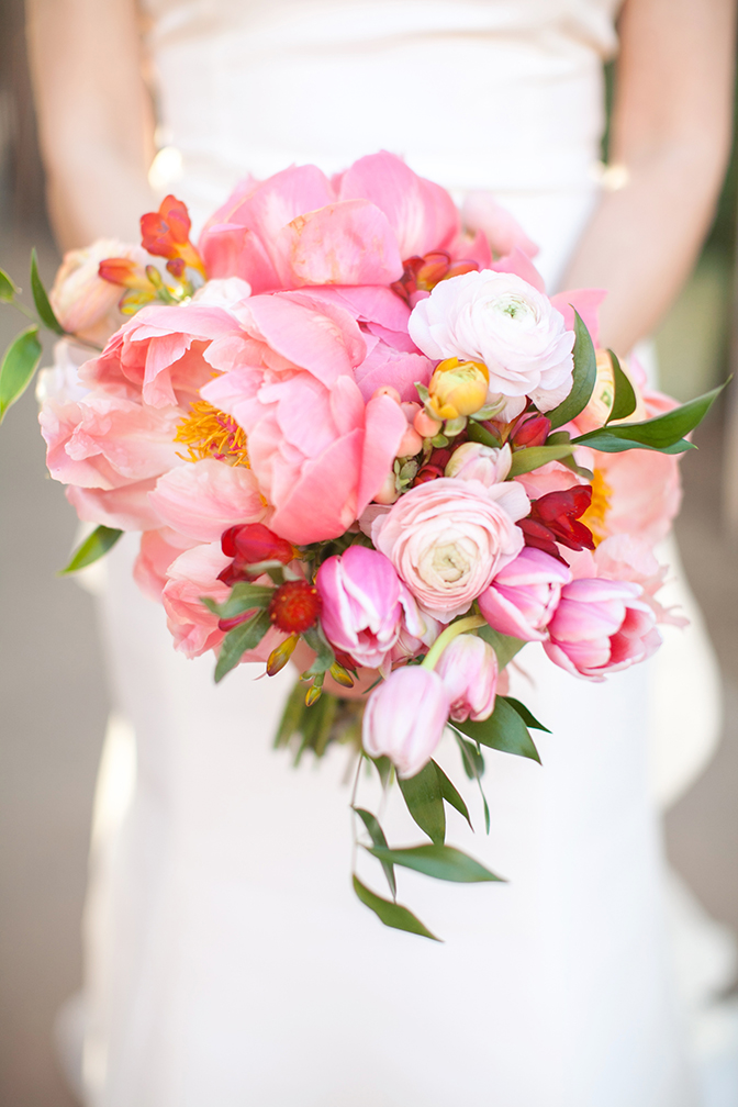 Lavish wedding bouquet of loosely designed pink flowers. Peonies, tulips, ranunculus.