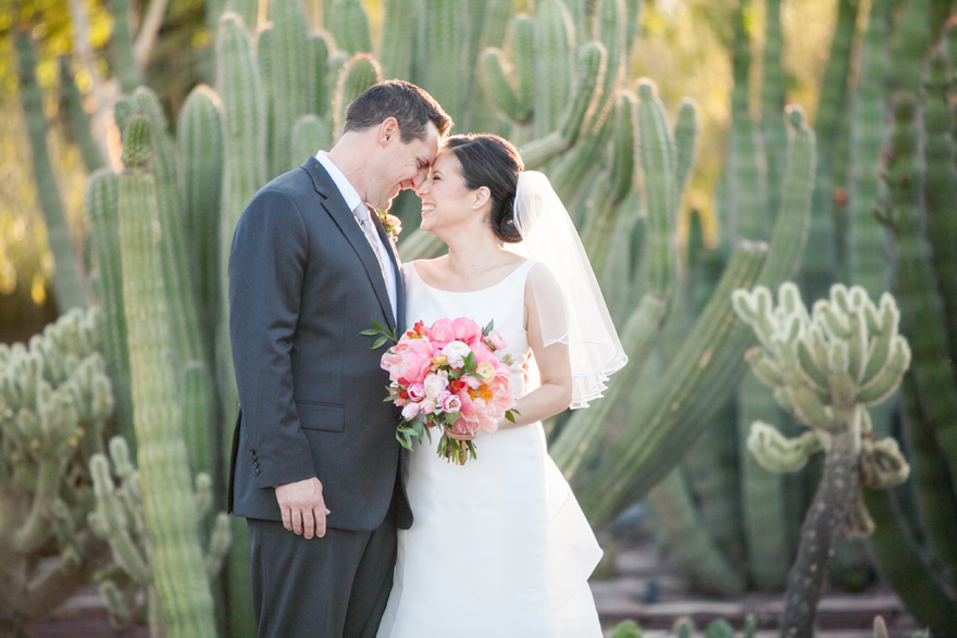 Laughing as the bride & groom nuzzle. Desert Botanical Garden cacti.