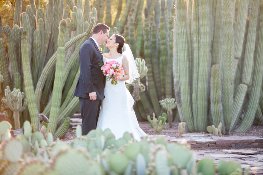 Happy bride & groom surrounded by cacti.