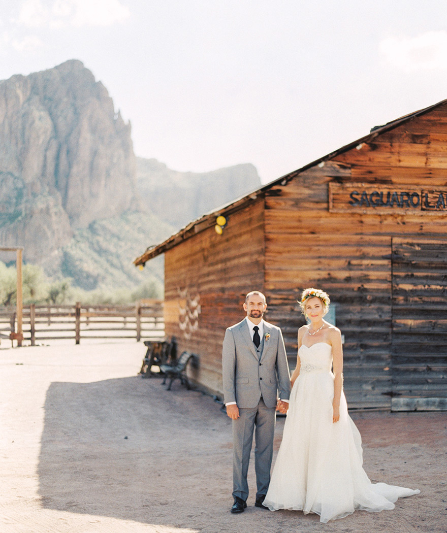 Bride and groom outside Saguaro Lake Ranch in Mesa, Arizona. Destination wedding with mountains
