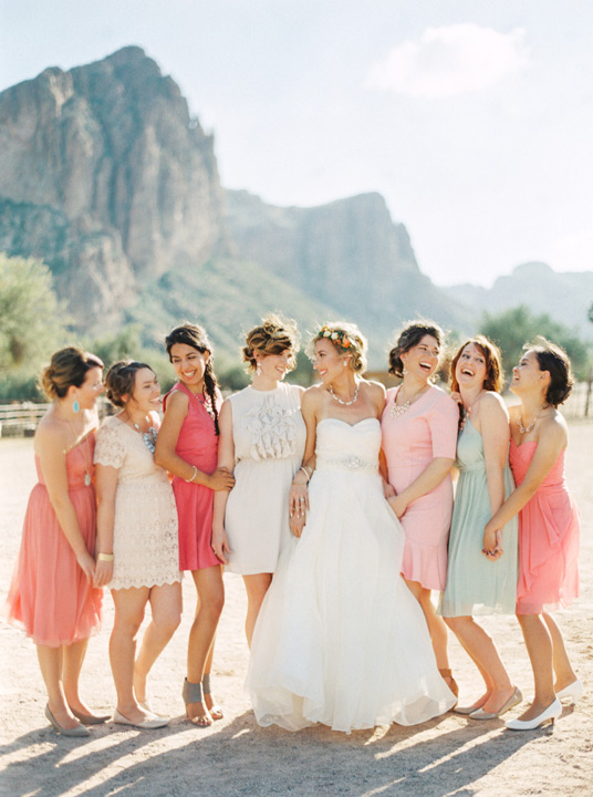 Bride and her bridal party enjoying the mountains and desert landscape. Short bridesmaids dresses. 