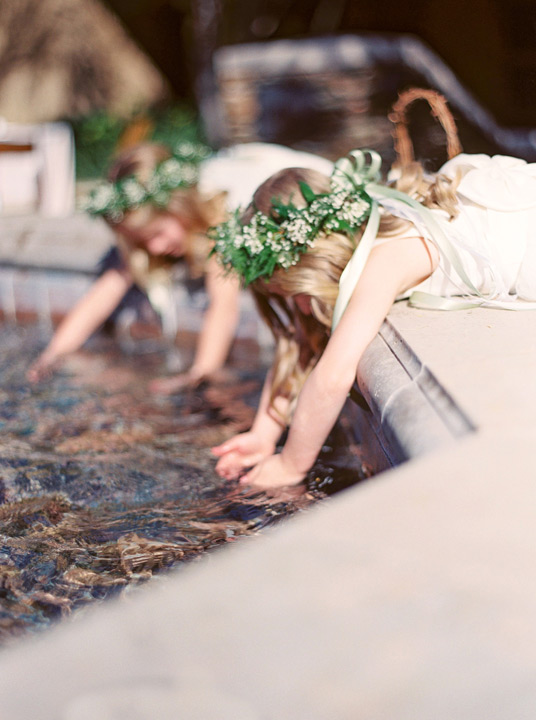 Flower girls play in the fountain in the Arizona desert. Venue is Sassi in Scottsdale, AZ. 