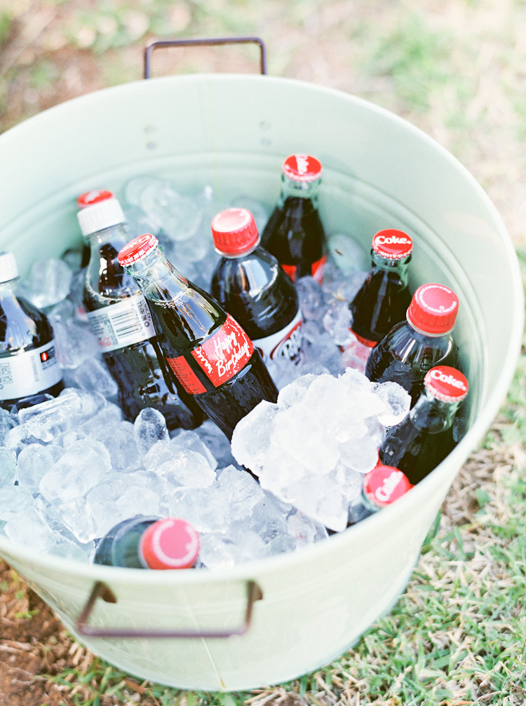 Birthday coke bottles in mint bucket.
