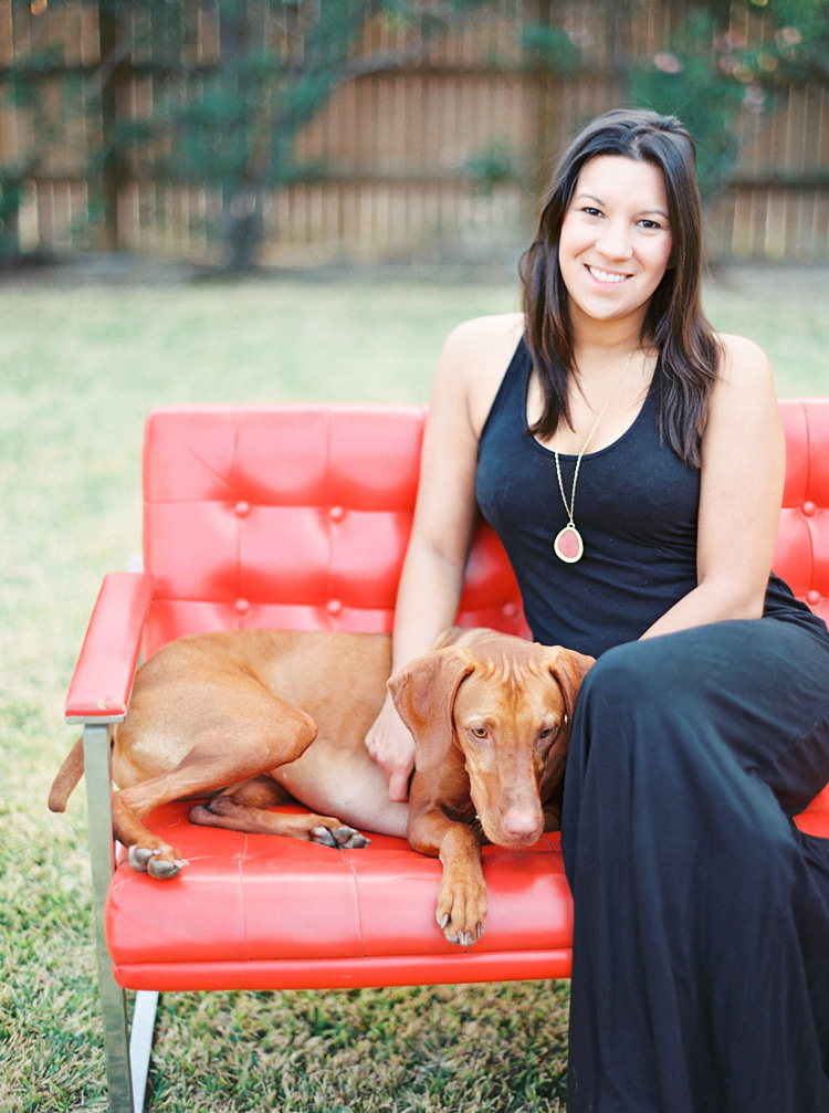 Brunette posed with golden brown puppy. Outdoor play date.