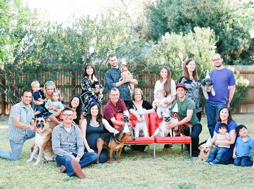 Outdoor gathering of friends and family with puppies.