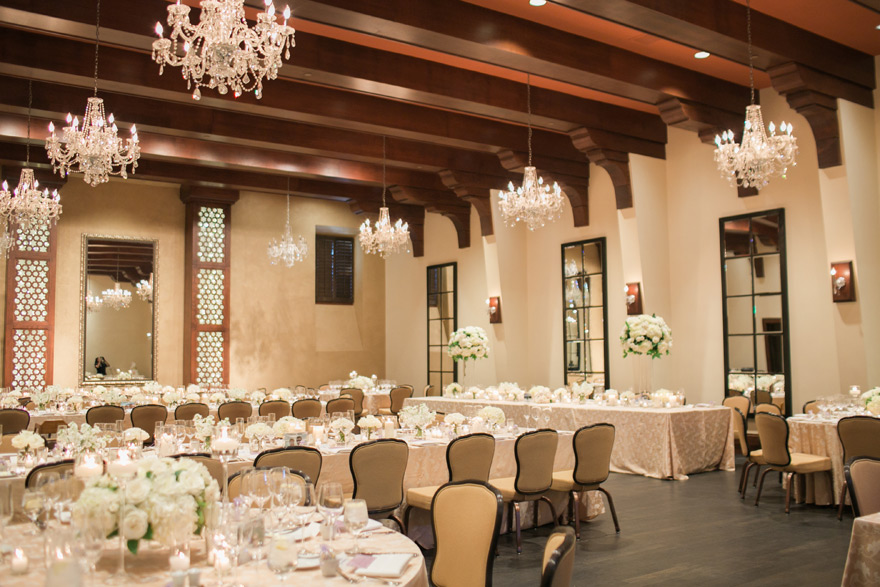 ballroom reception with candlelight and white flowers
