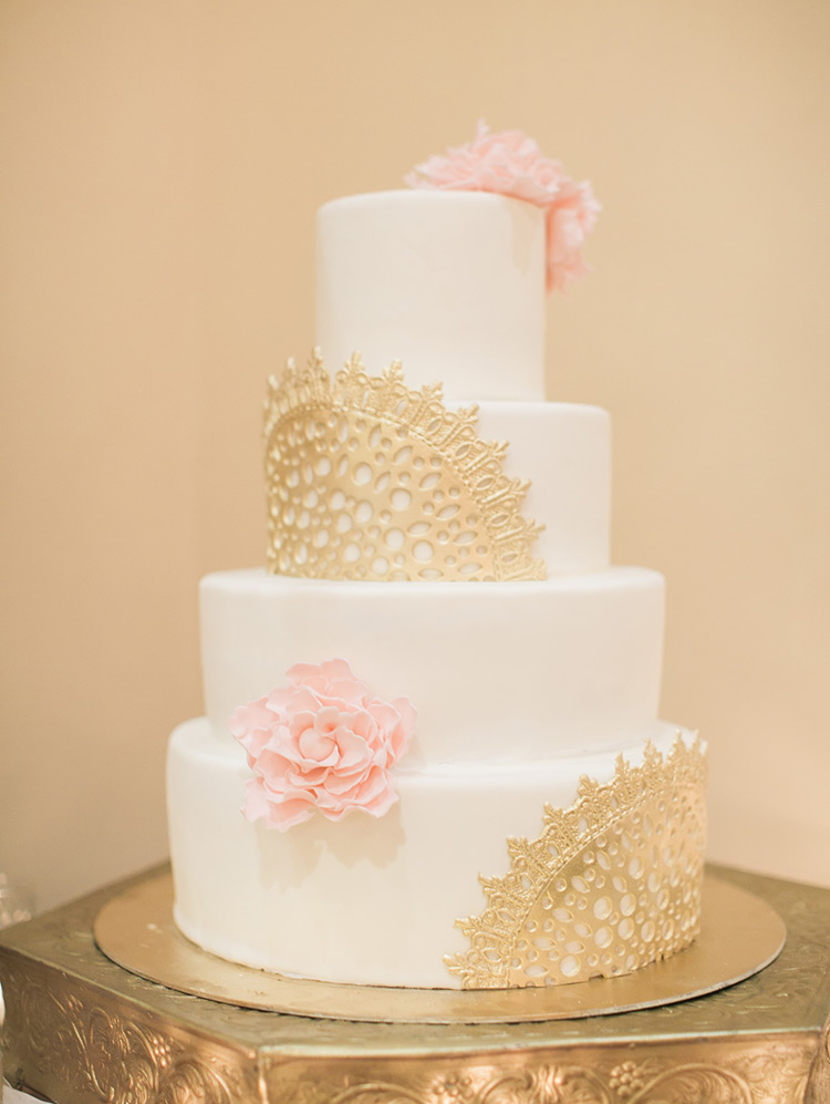 wedding cake with gold lace and sugar flowers