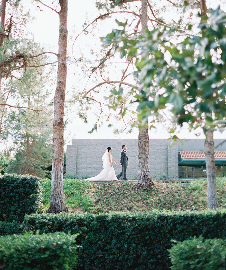 bride & groom walk hand-in-hand at Hyatt Scottsdale