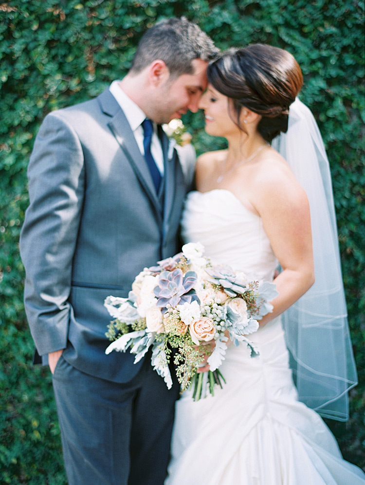 elegant bride & groom, pale peach bouquet with succulents & dusty miller