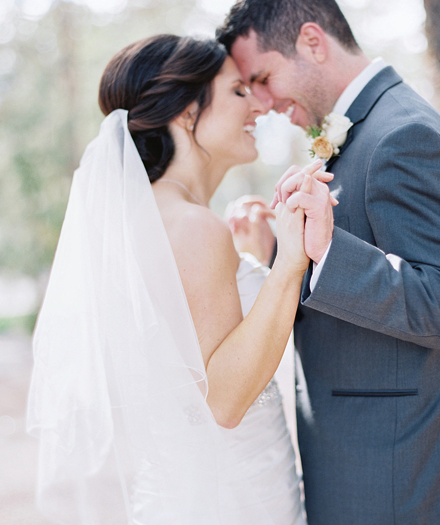 joyous bride & groom clasp hands