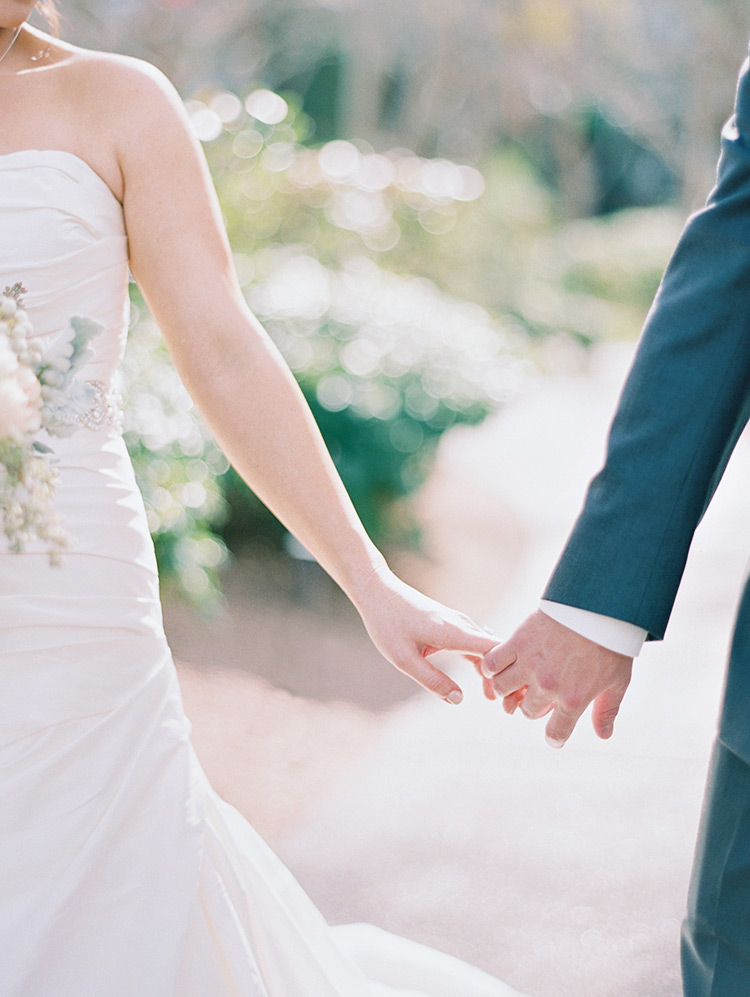 bride & groom holding hands