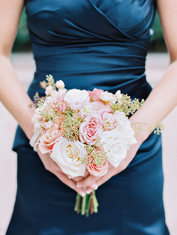 bridesmaid in midnight blue satin, pink and peach bouquet