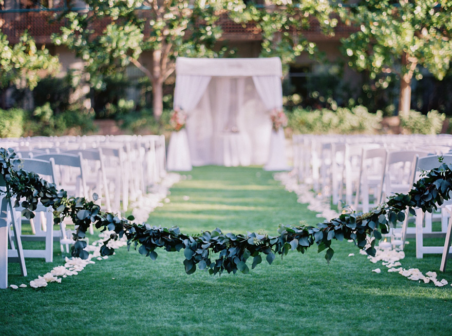 garland drawn across the aisle, outdoor wedding ceremony