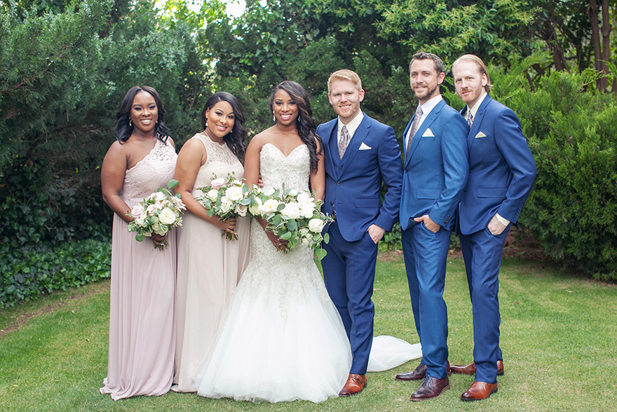 Blue suits for the groomsmen and pale lace for the bridesmaids