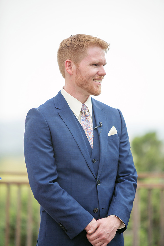 groom in a blue suit with a paisley tie