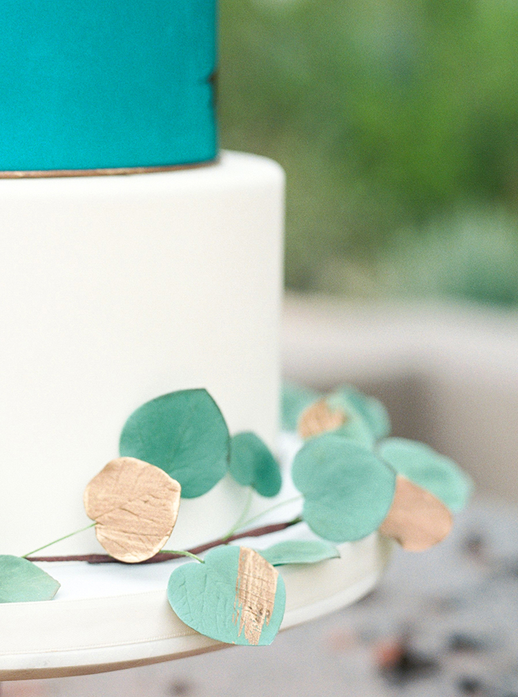 Gilded sugar flowers on an elegant cake