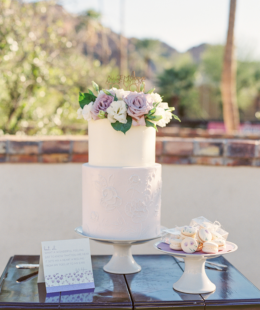 Delicate lavender & white cake with handprinted macarons