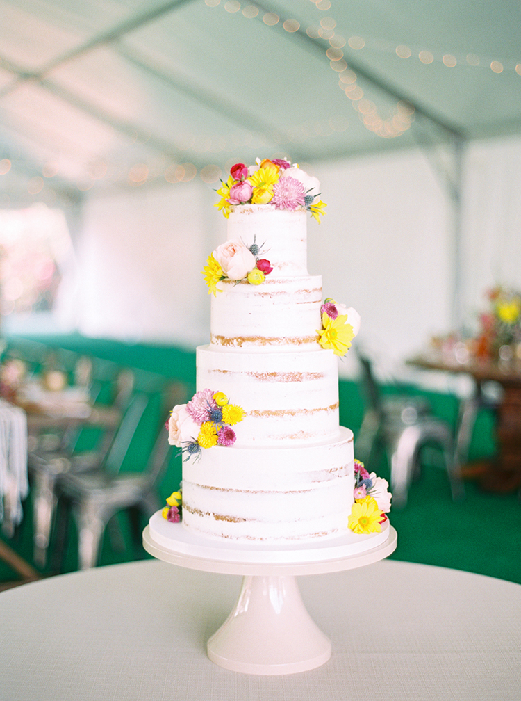Nearly naked cake decorated with vibrant flowers