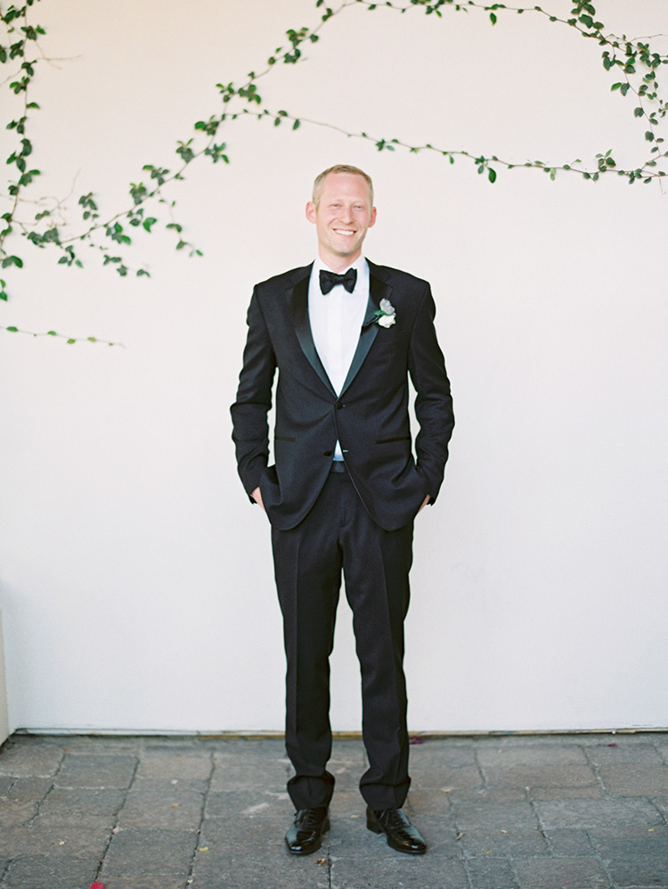 groom in a classic black tux