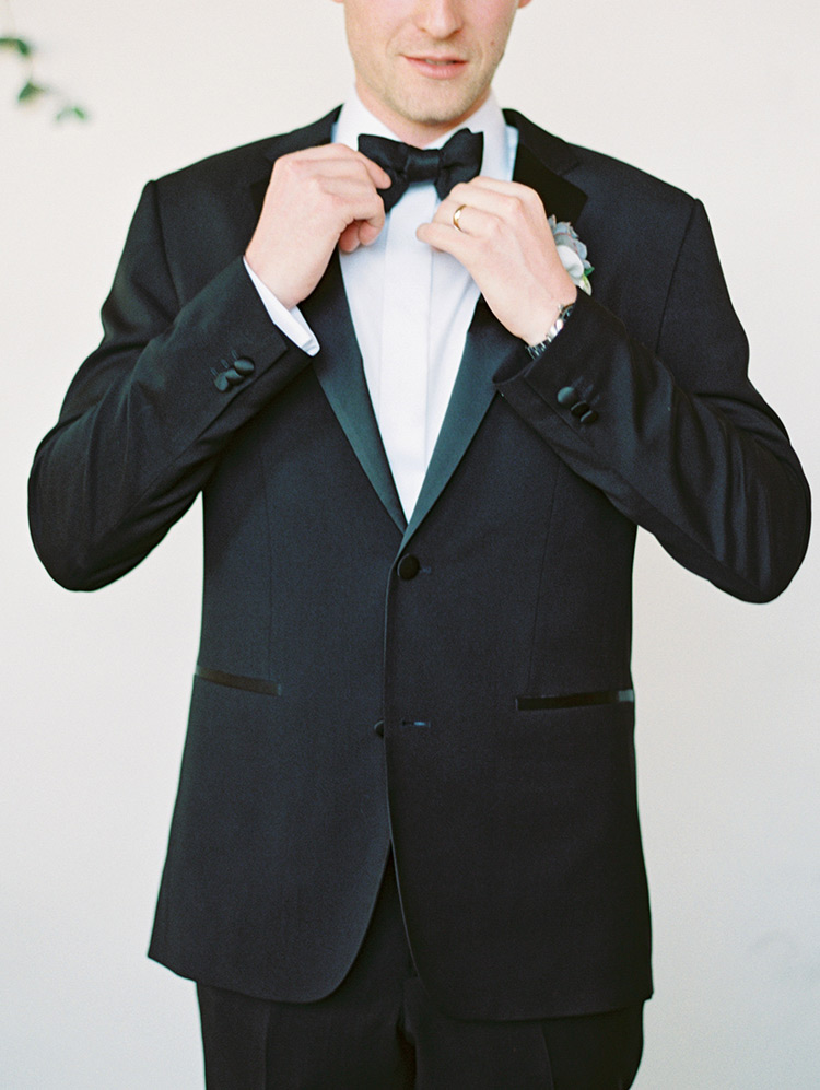 groom in a classic black tux
