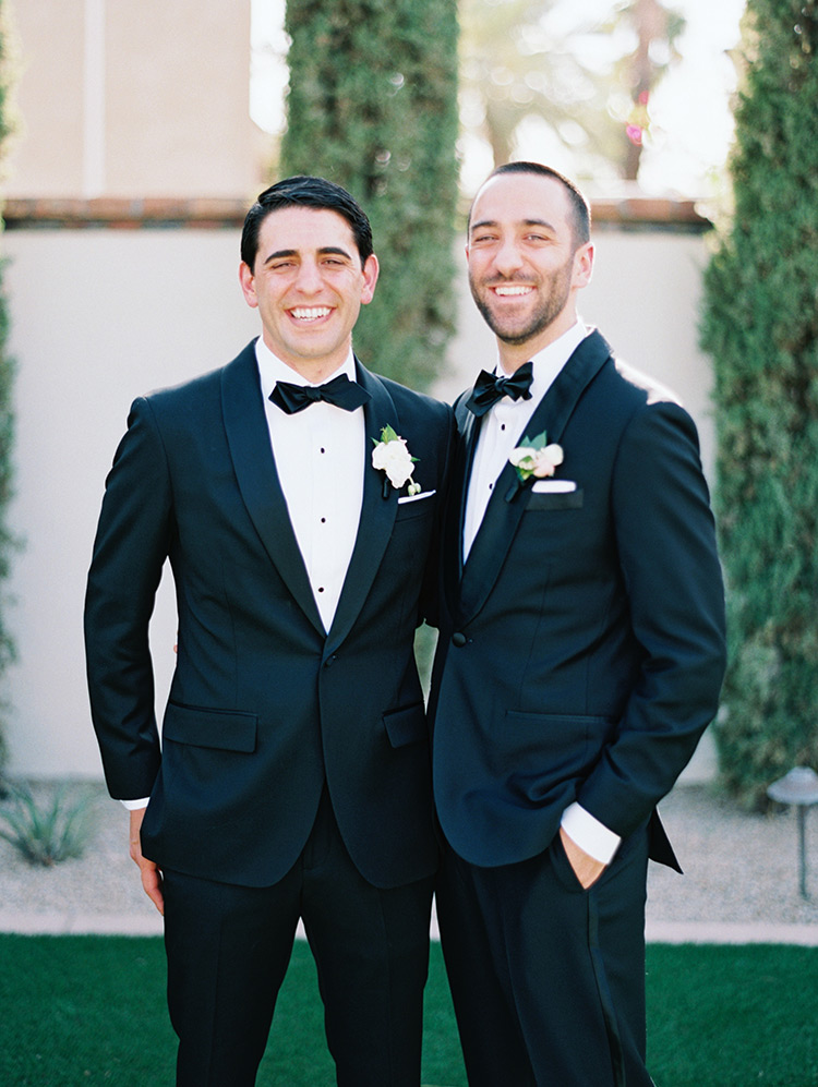 groom & groomsman in black tuxes