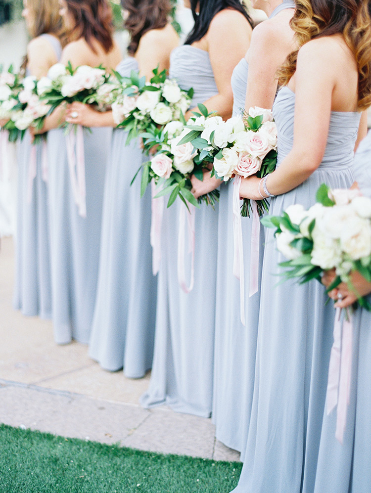 bridesmaids in grey with blush bouquets